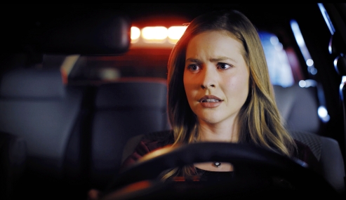 Young woman being pulled over by police officer